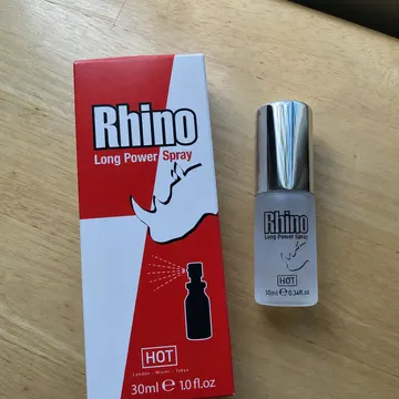 The Rhino Long Power Spray carton and its 10 ml bottle on a wooden table
